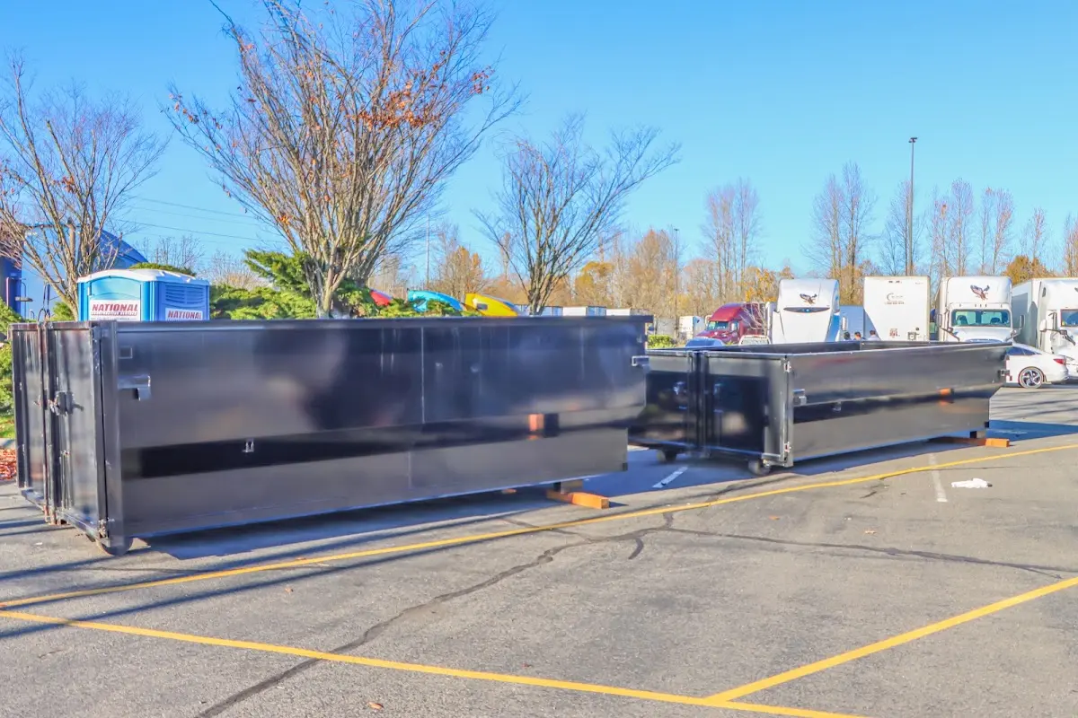 Professional dumpster rental service with roll-off container on residential driveway in Prospect Heights